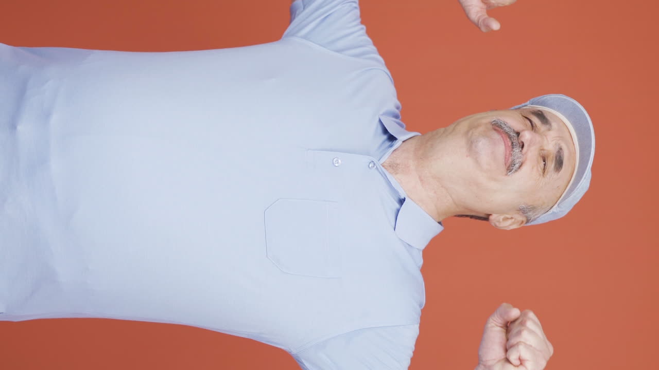 Vertical video of Sleepy old man yawns.