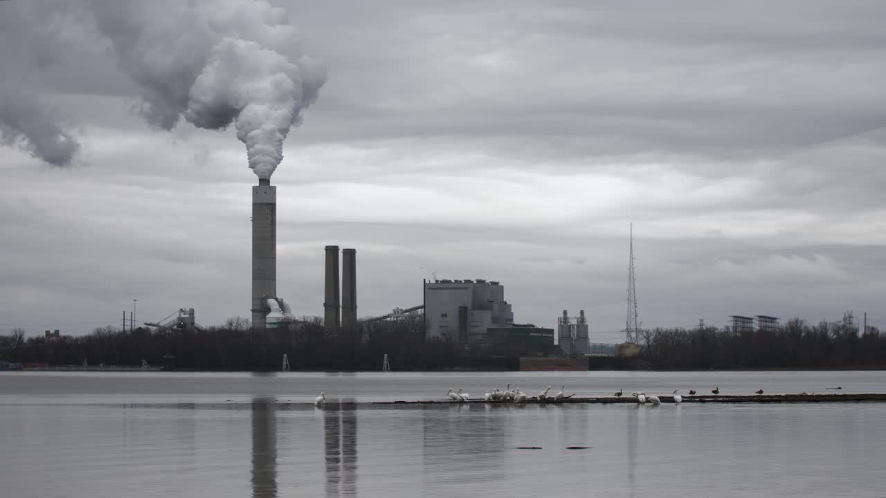 Smoke coming out of a smoke stack at a coal-fired power plant across the river