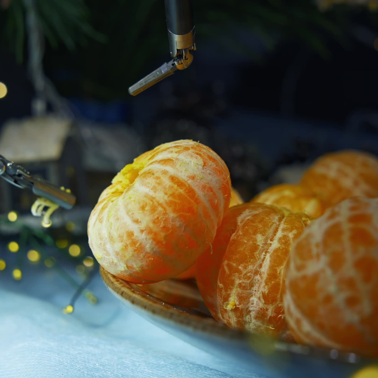 Gadget humanoid peels tangerine while preparing to the Christmas. Cropped view. Computers and cyber droid concept