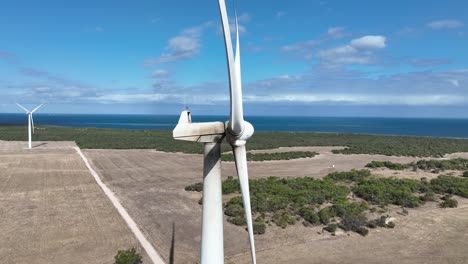 stationary drone shot of spinning wind turbine