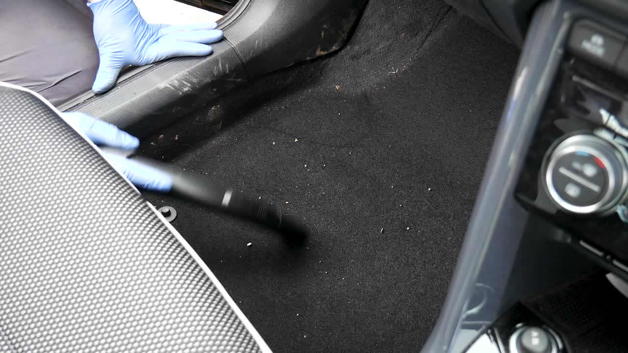 Hovering dirty car interior carpet