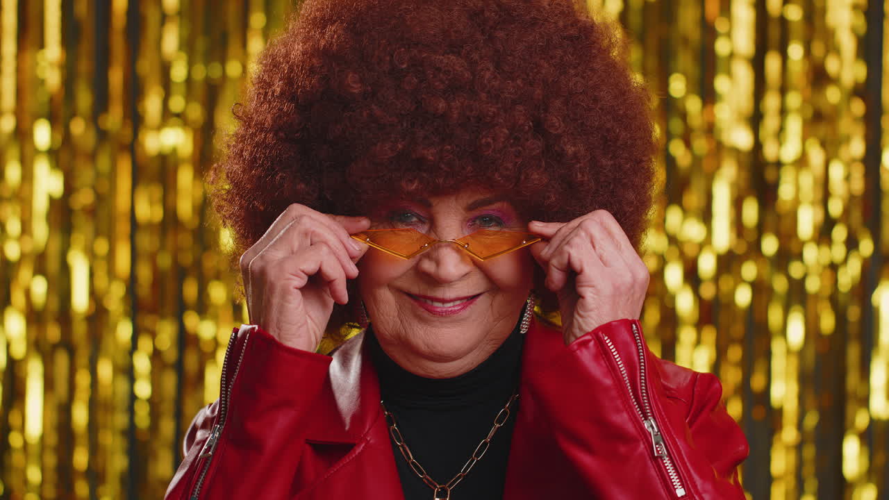 Playful happy woman wearing sunglasses blinking eye looking at camera with smile, winking, flirting