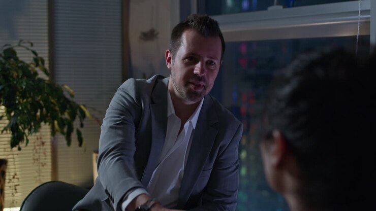 Businessman Talking on the Phone and in a Meeting at Night