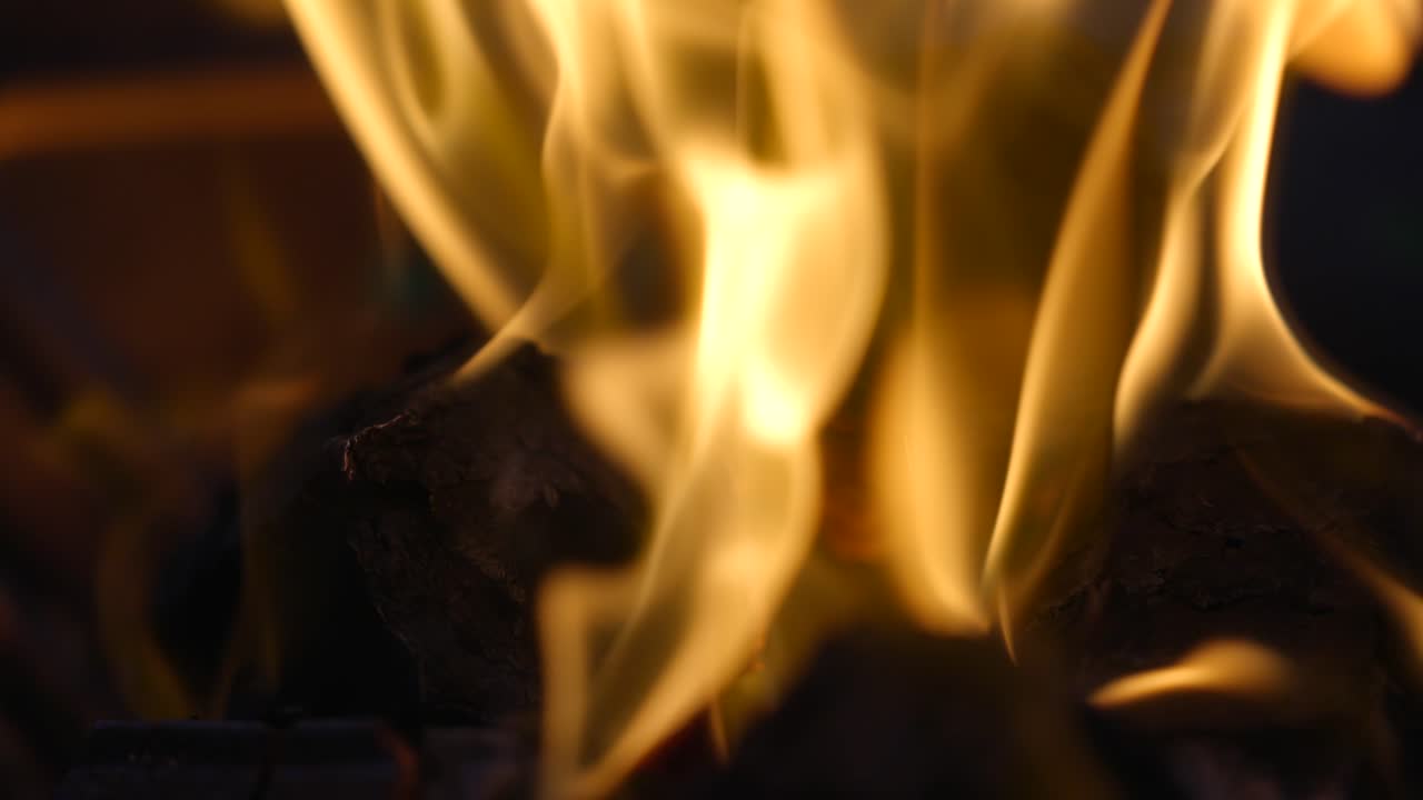 Slow motion close up video of fire over woods