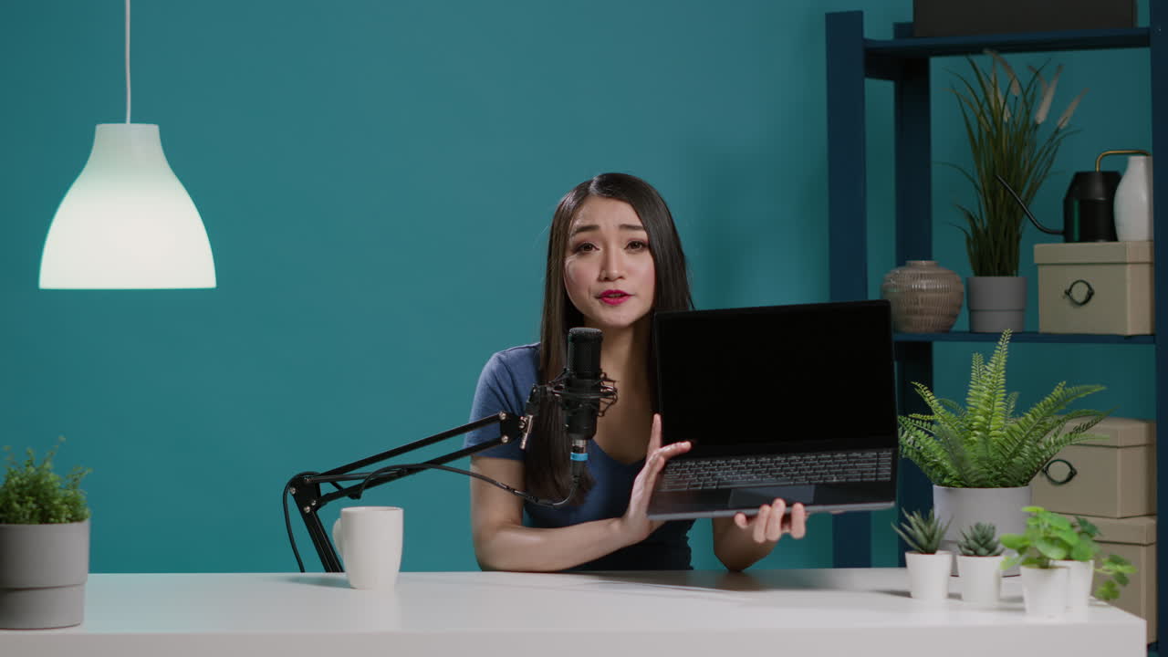 POV of female vlogger doing laptop review on camera