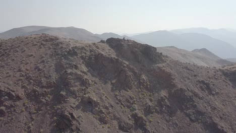 Aerial-Drone-Shot-of-Group-of-People-on-Mountain-in-Death-Valley