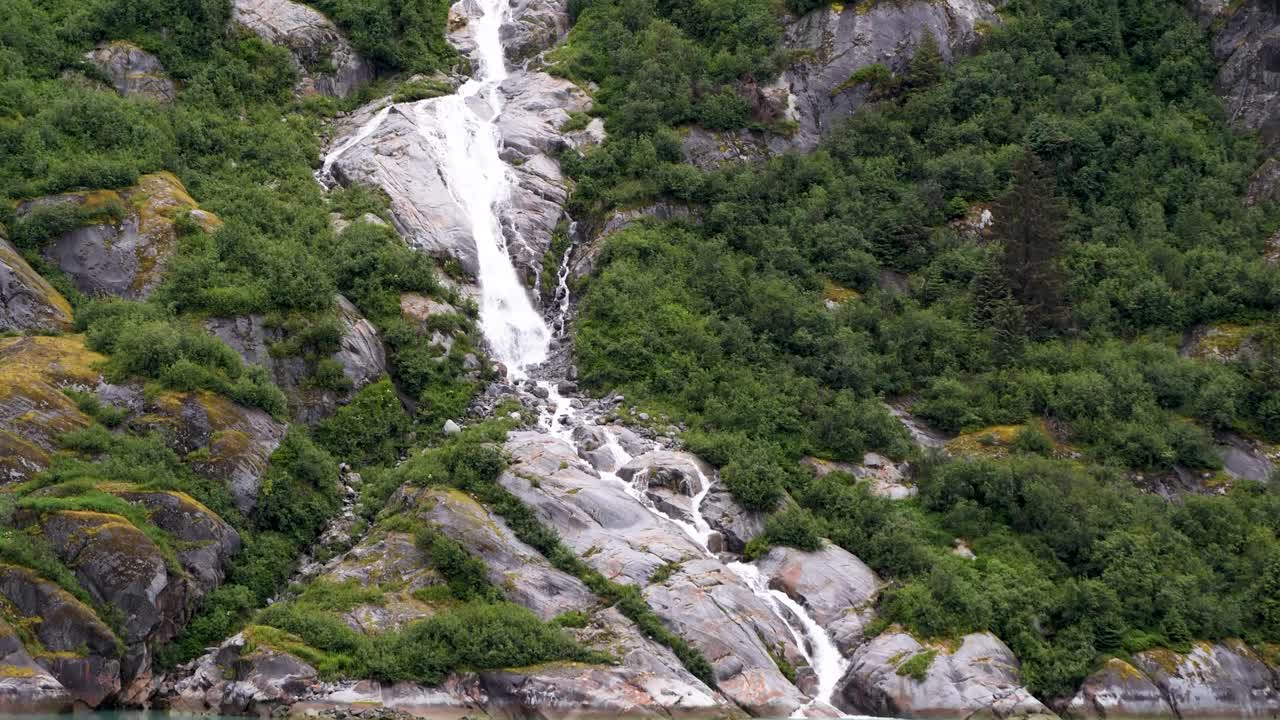 Waterfall's pristine glacial meltwater plunges into tidewater at Endicott Arm fjord,Tongass National Forest, Alaska.