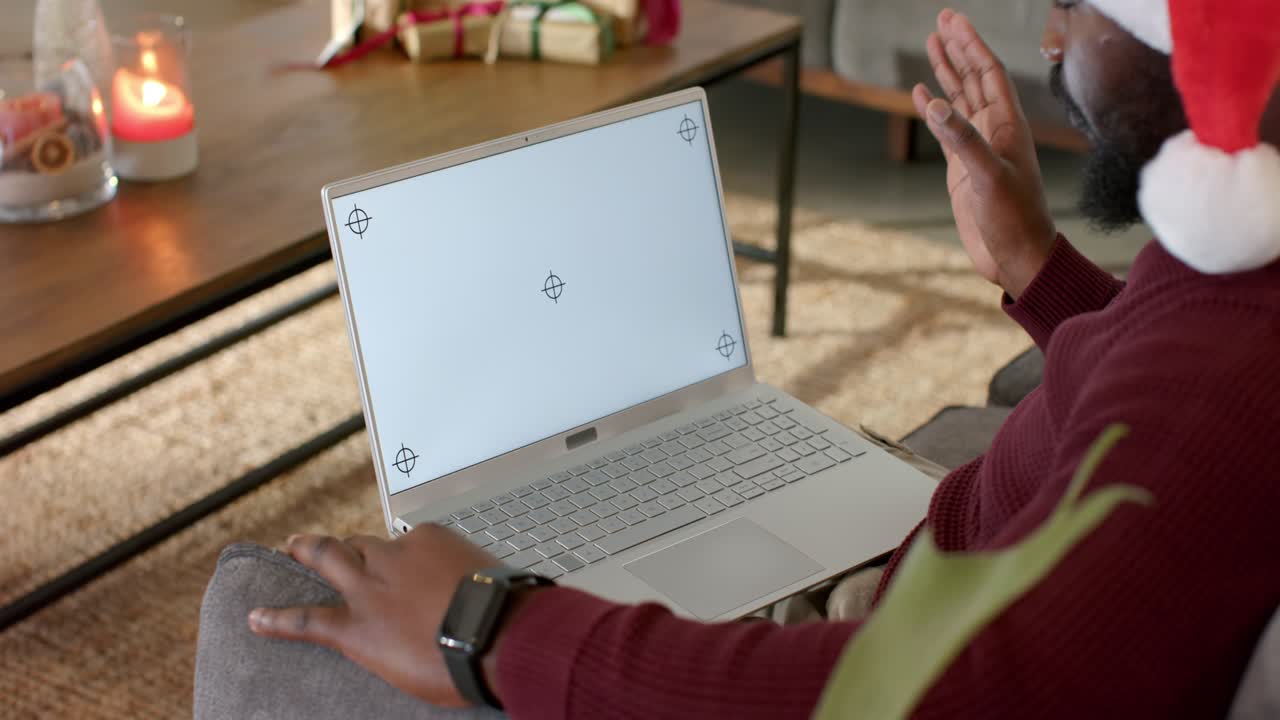 After call start man is placing hand on laptop and gesturing then waving in holiday chat