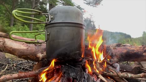 cooking pot on flaming campfire, highlands, scotland