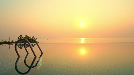 a resort pool shimmers with color from the setting sun
