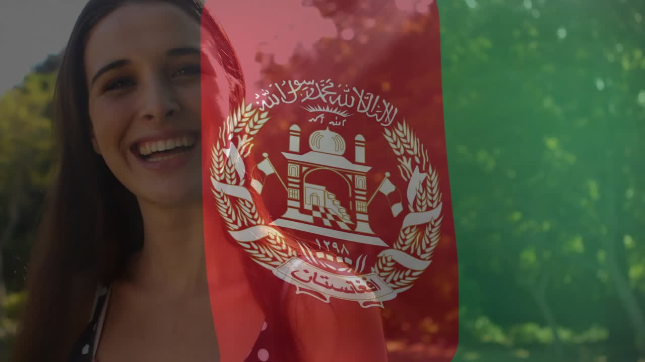 Woman standing outdoors in park, using animated flag overlay under sunlight for education campaign