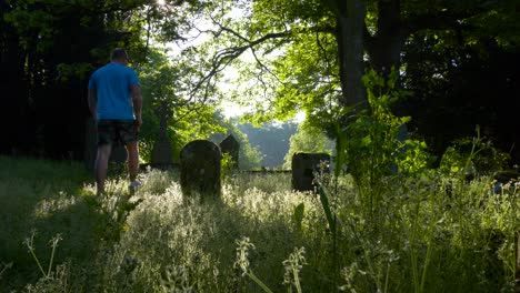 A-Man-Is-Walking-Inside-The-Ground-Of-Unused-Cemetery-In-County-Wexford,-Ireland