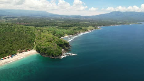 Amplia-Vista-Aérea-Panorámica-De-La-Costa-Este-De-Bali-En-Pantai-Prasi-Con-Océano-Azul-Y-Playa-De-Arena-Blanca-En-Un-Día-Soleado