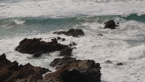 Hand-held-shot-of-waves-crashing-against-dangerous-rocks-at-Fistral-Beach