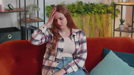 displeased young woman rubbing temples to cure headache problem, suffering from tension and migaine