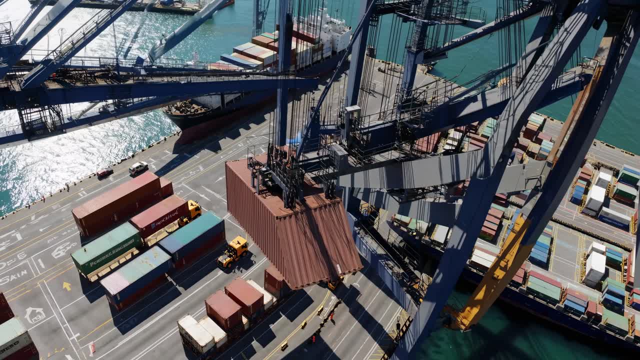 Aerial view of a bustling port with cranes loading containers onto ships