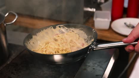 preparing creamy pasta dishes in a kitchen