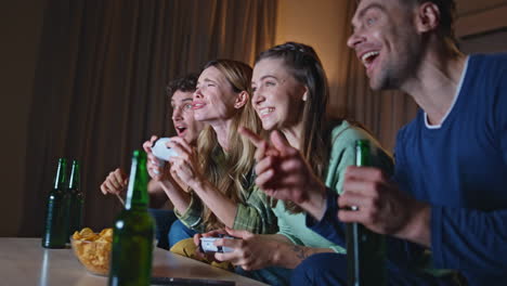 joyful friends competing video game at home couch close up. team rejoicing