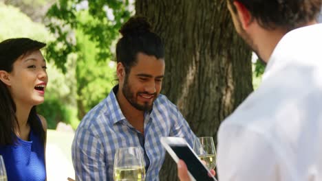 Couple-interacting-with-waitress