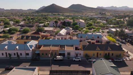 aerial view of a residential area with houses and mountains in the background
