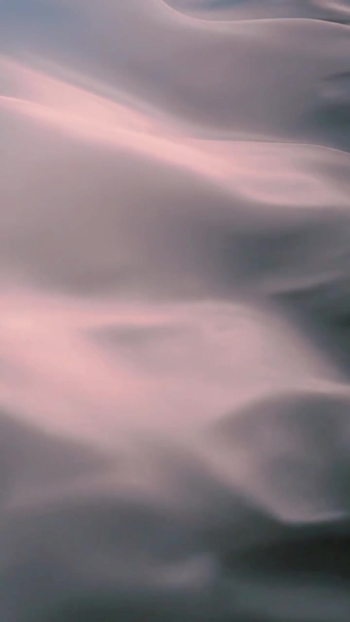Abstract Background of Soft Pink Fabric Waving in Slow Motion