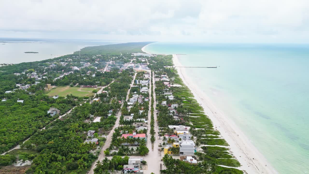 Tropical beach town with lush greenery, sandy shores, and a scenic ocean view