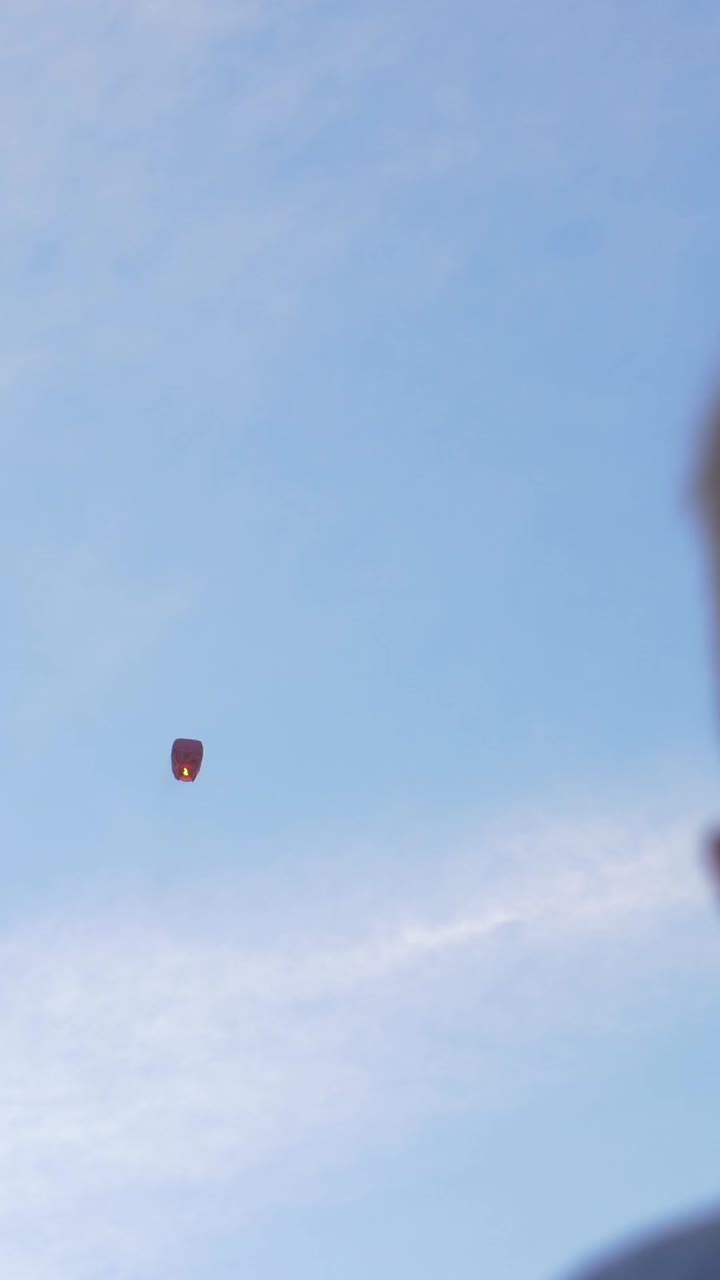 Boy releasing a sky lantern into the sky