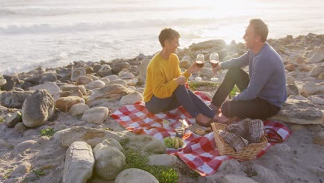 couple drinking wine by the sea