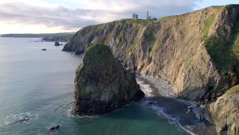 drone static with sea stack calm seas and ruins of old copper mine on cliff top