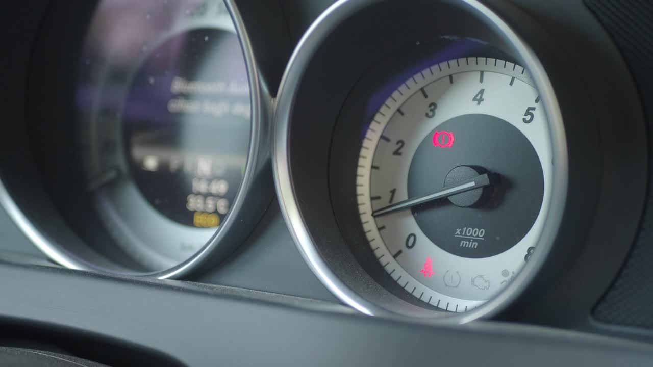 Close-up of a car dashboard with illuminated warning lights