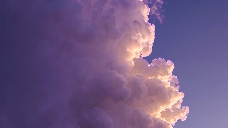 A mesmerizing video of towering clouds at sunset, captured from a low angle, showcasing a serene