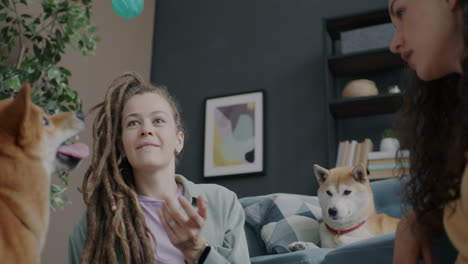women playing with dogs in the living room