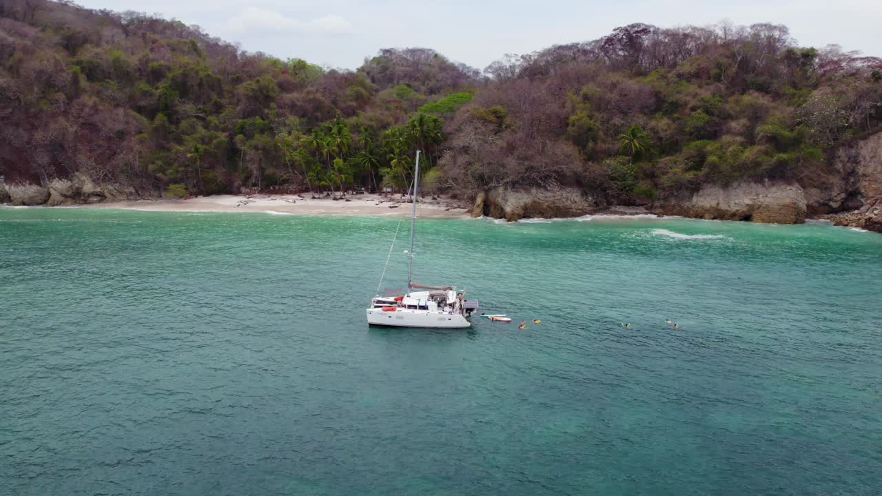 Summer holiday swimming and sailing in tropical waters of Curu Bay, Costa Rica