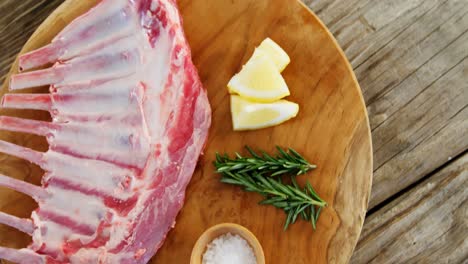 costillas de carne cruda e ingredientes en tablero de madera