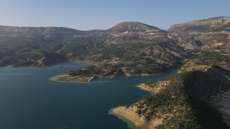 -Aerial-view-of-the-blue-lake-and-green-forests-on-the-lake-between-mountain-forest