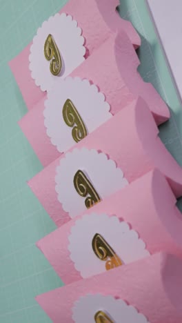 neatly arranged pillow shaped candy boxes ready to present. vertical shot