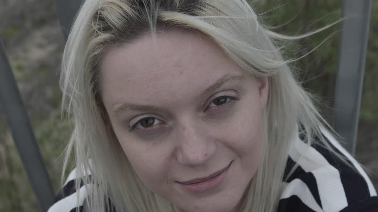 Natural young female person looking into the camera,close up slow motion shot