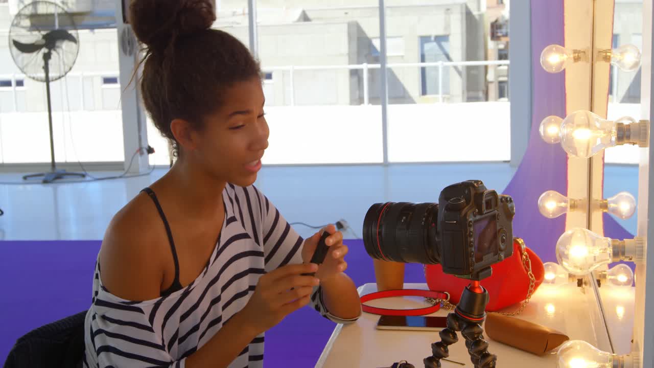 Model applying make up in photo studio 4k