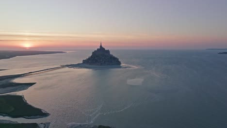 approaching  mont st michel at sunset