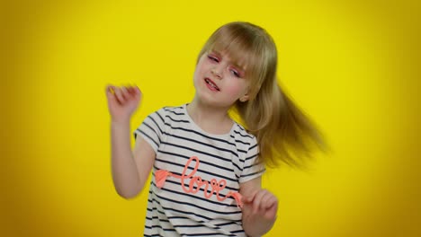 Little-teen-kid-child-girl-in-striped-t-shirt-listening-music-dancing-disco,-fooling,-having-fun