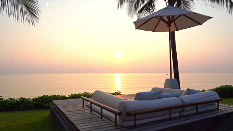 Tropical-Sunset-on-Caribbean-Island,-Outdoor-Couch-and-Lookout-View-of-Sea-Horizon