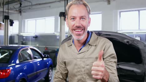 mechanic checking tyre and showing thumbs up