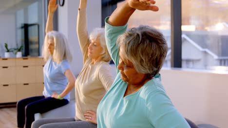 senior women performing yoga 4k