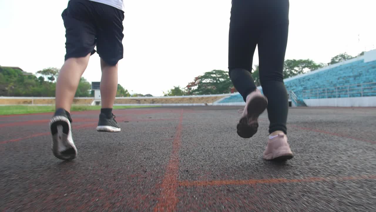 Leg'S Boy And Girl Running At Stadium