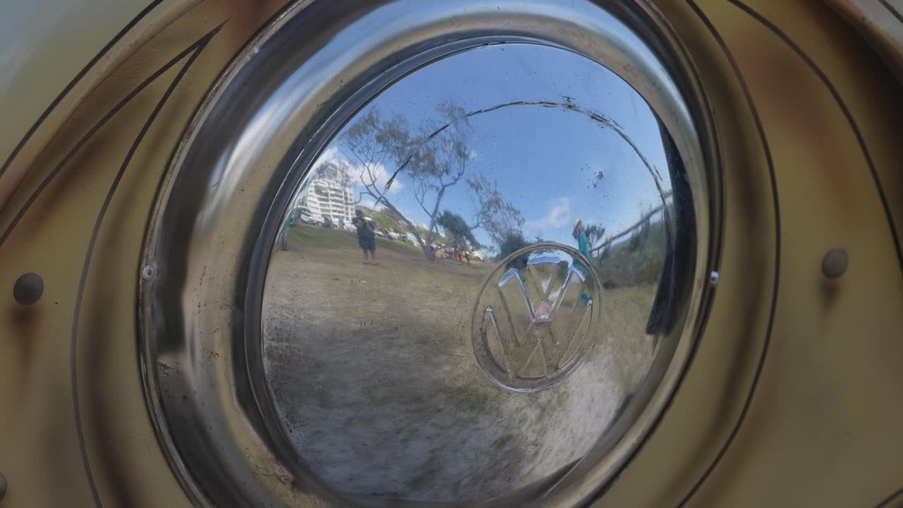 Kangaroo sculpture reflected in a Volkswagen hubcap