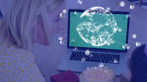 Animation-of-globe-spinning-over-smiling-caucasian-mother-and-daughter-using-laptop