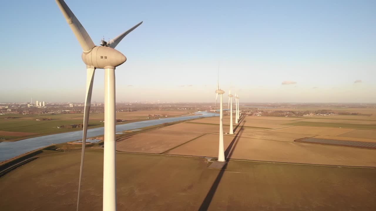 Slow motion: wind turbines in a golden field