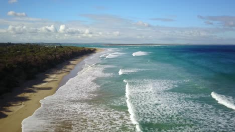 low drone flight over ocean waves at inverloch, victoria, australia