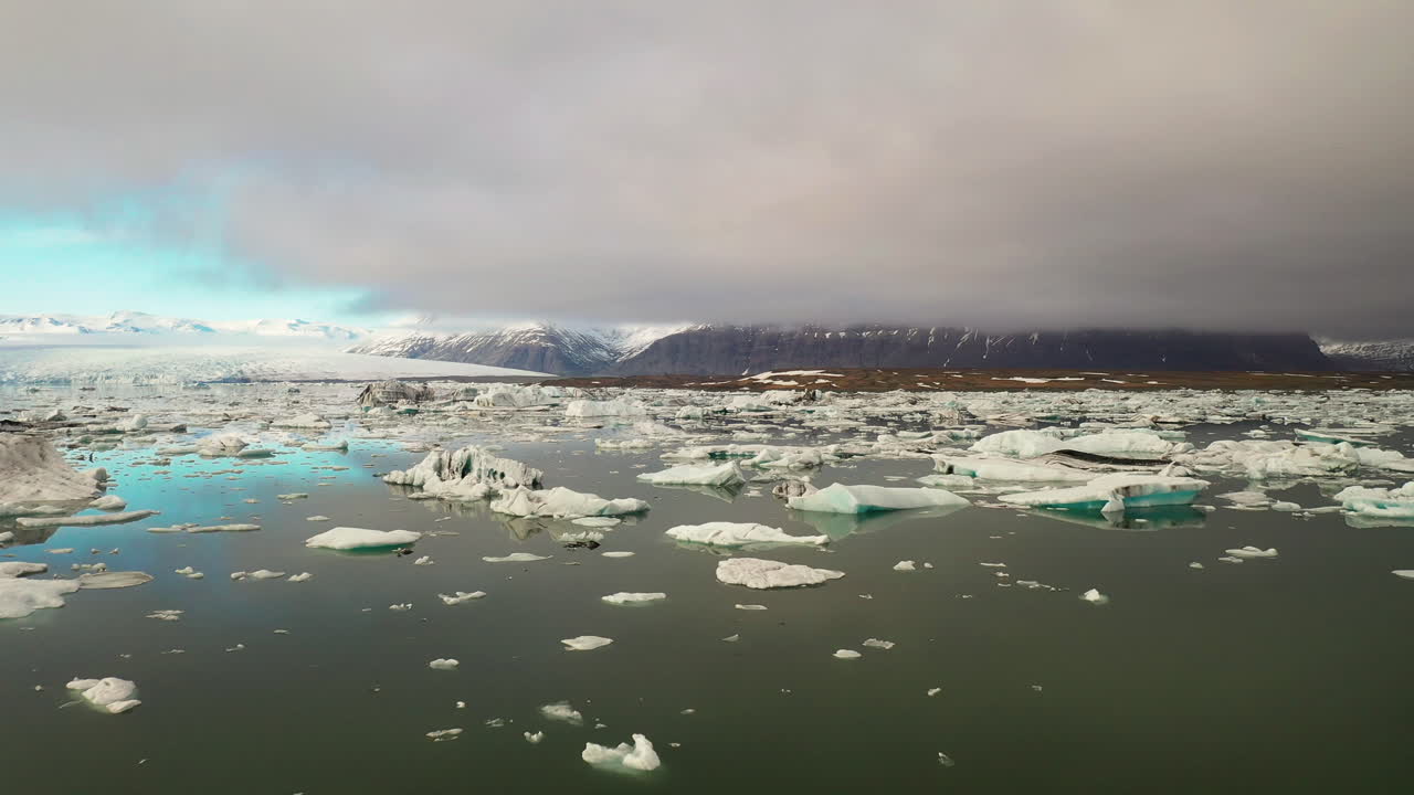 Flying over icebergs on clam glacial lake Jökusarlon in south Iceland - Ring road Drone 4k footage