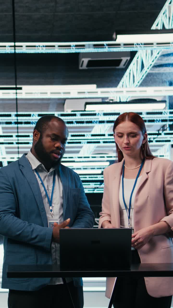Vertical video Data center coworkers collaborating to manage cloud computing IT solutions